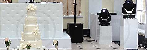 White Chesterfield-style DJ Booth on a 1ft riser for a white wedding